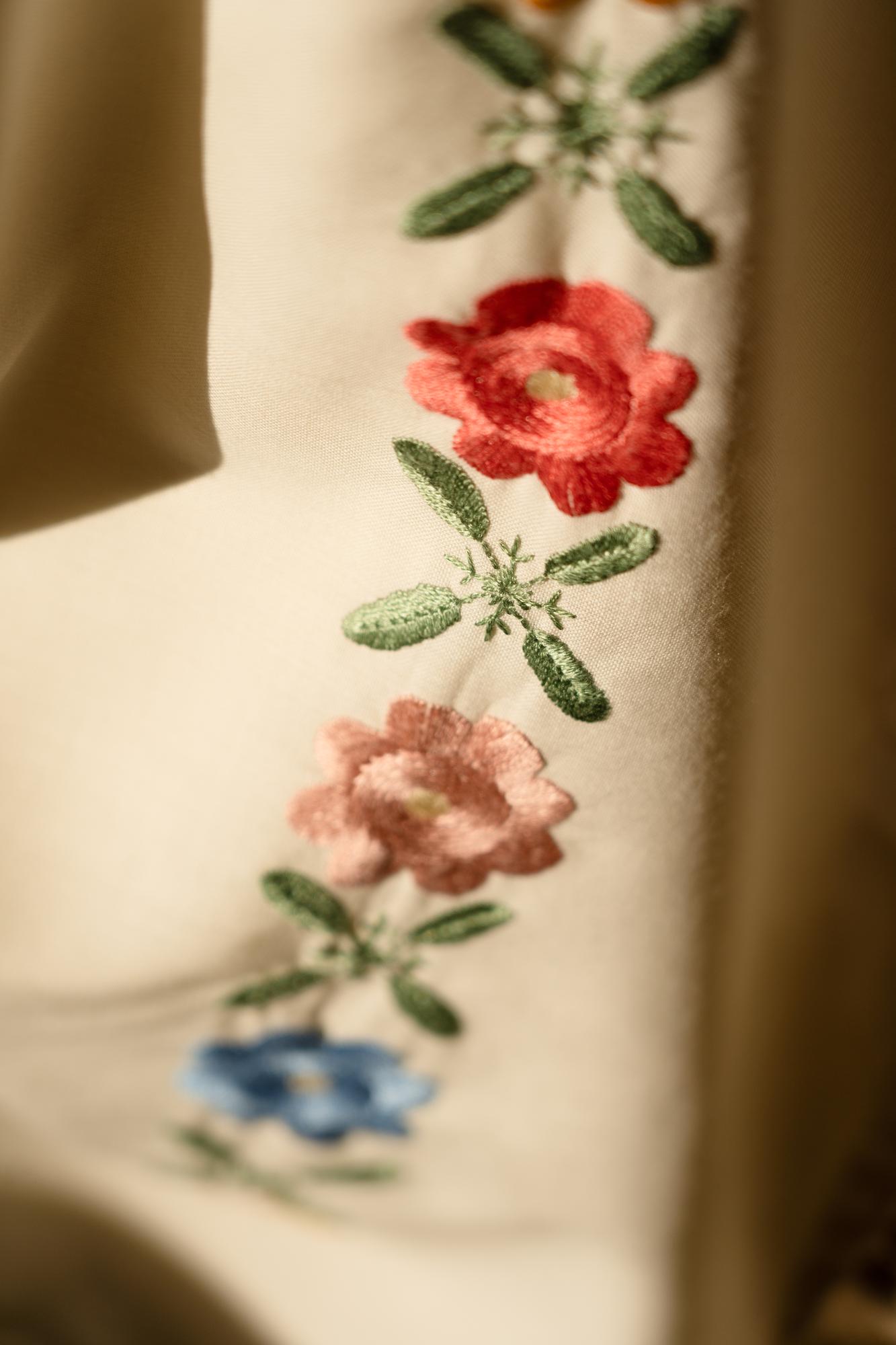 Close-up of embroidered floral patch on linen